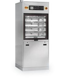Pass-through autoclave installed in a laboratory corridor with loading trolley
