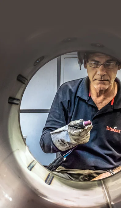 Tuttnauer technician inspecting an autoclave chamber